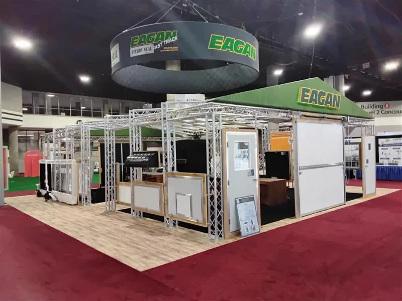Large open exhibit displaying industrial systems beneath circular overhead signage.