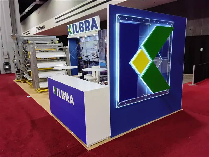 Compact equipment island with illuminated corner graphics and a service counter.